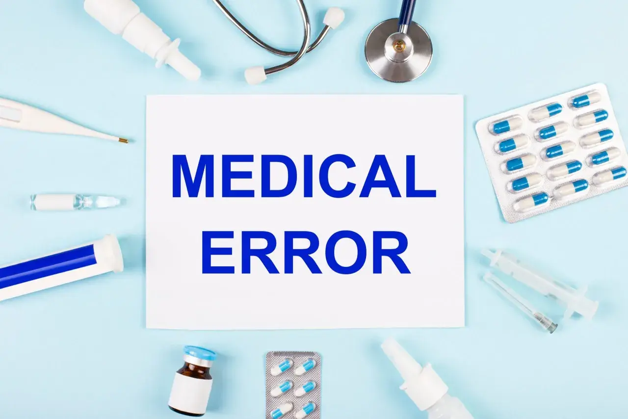 Papier avec "MEDICAL ERROR" entouré de matériel médical. Une situation qui peut mener à dénoncer un médecin.